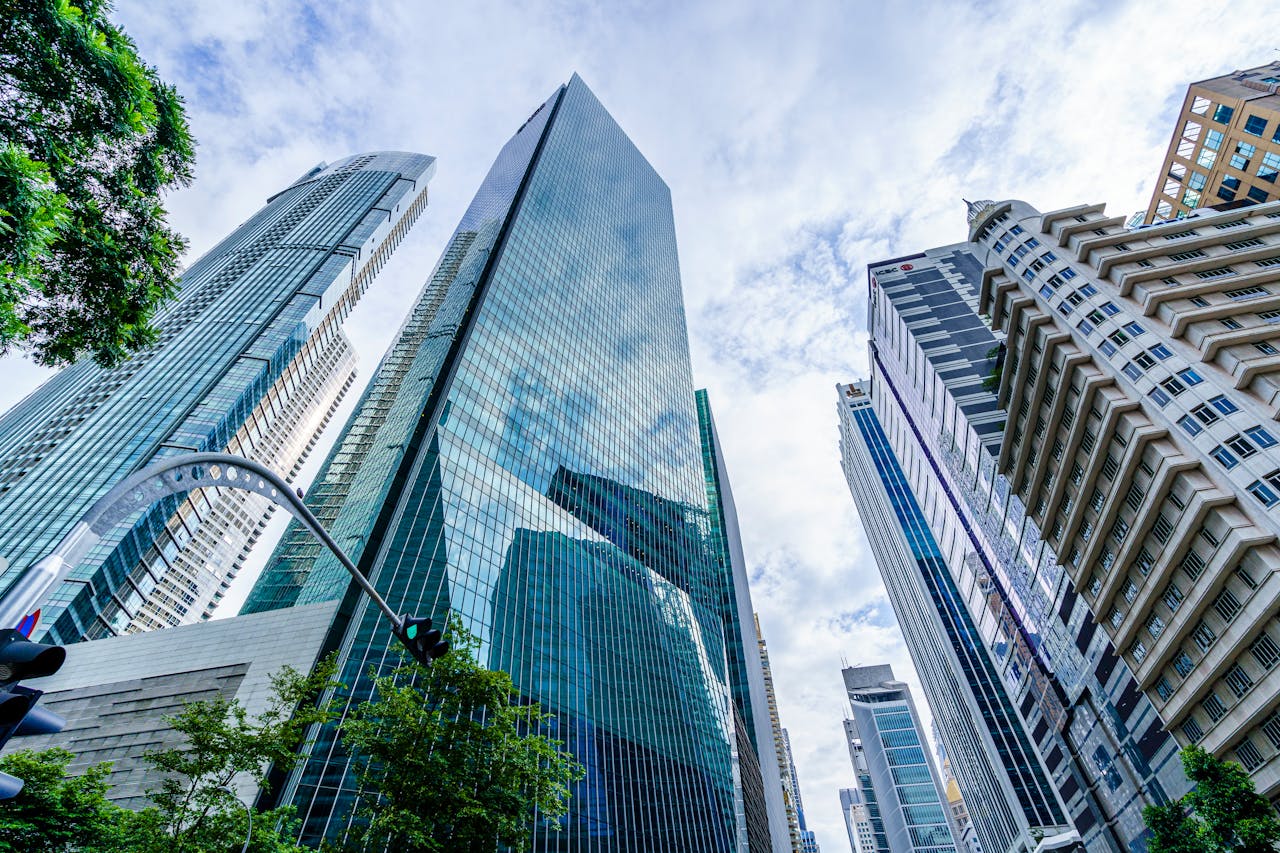 Low angle view of modern skyscrapers against a blue sky in an urban downtown setting.